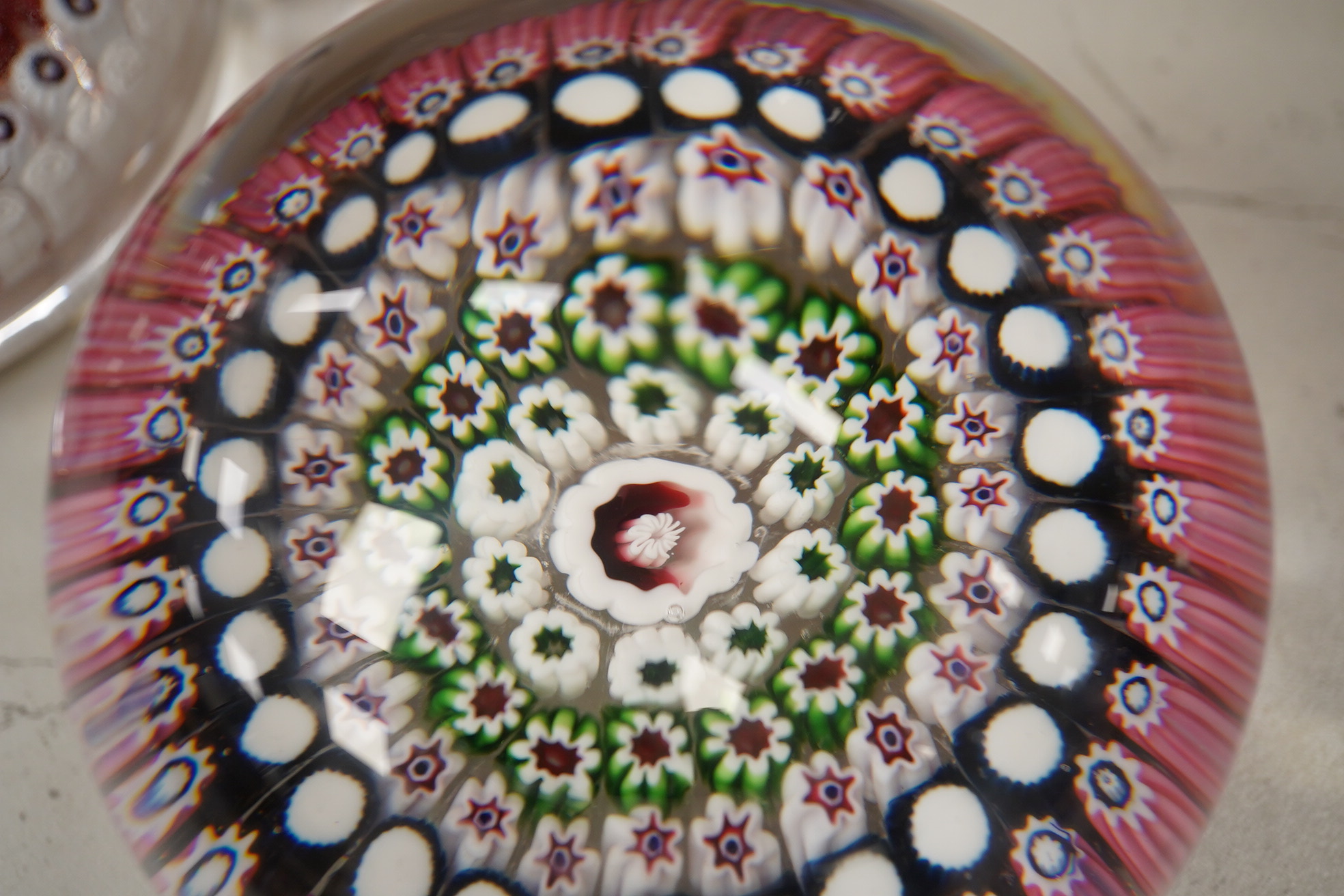 Two Victorian English millefiori glass paperweights, 7cm tall. Condition - fair to good